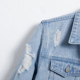 Men's light blue ripped denim jacket.