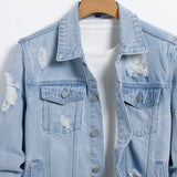 Men's light blue ripped denim jacket.